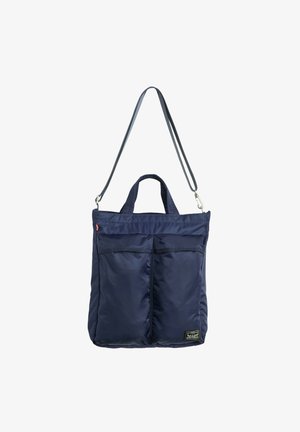 Sac fourre-tout en nylon bleu marine avec deux poches avant, poignées courtes et une longue sangle d'épaule amovible.
