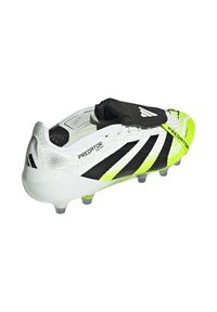 White and black soccer cleat with neon yellow accents, textured surface, and a sock-like collar for ankle support. Predatory design elements featured.