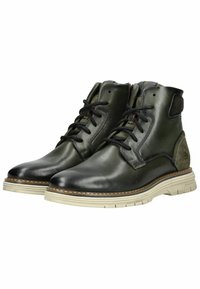 Botas de tobillo de cuero negras y verdes con un acabado suave, puntera redonda, parte delantera con cordones y suela de goma beige en contraste.