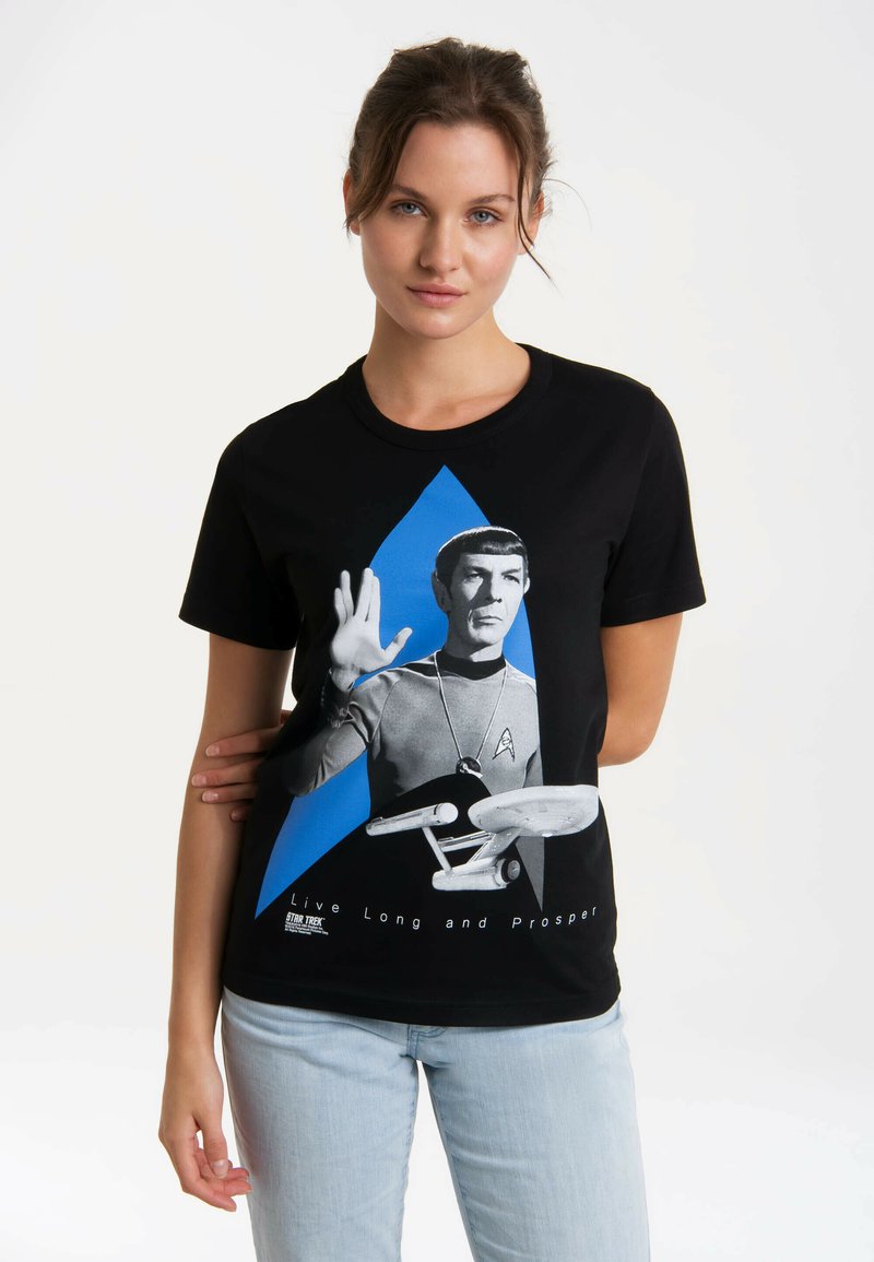Black cotton t-shirt featuring a graphic of a character with raised hand and starship. Blue triangle accent and white text: "Live Long and Prosper."