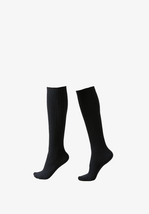 Chaussettes noirs montantes en maille côtelée, avec un orteil lisse et une bordure extensible pour plus de confort.