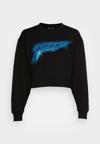 Sudadera negra recortada con mangas largas y logo estilizado en azul "guess" en el pecho con un efecto de resplandor punteado.