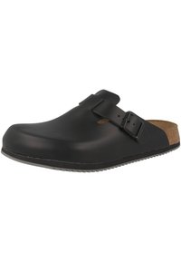 Black clogs with a smooth, matte finish. Cork insole, adjustable metal buckle, rounded toe, and textured rubber outsole for grip.