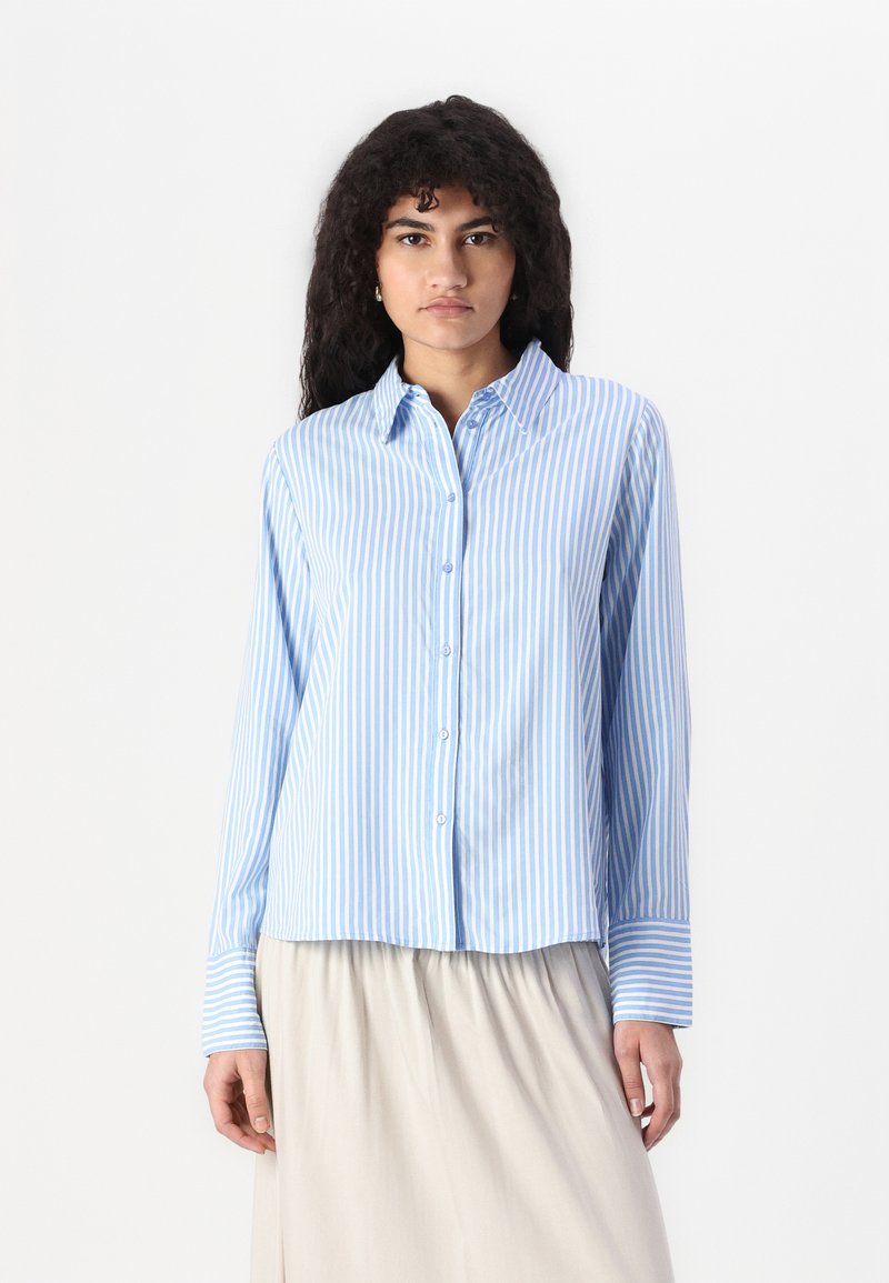 Light blue and white striped long-sleeve shirt with a collar, button front, and cuffs. Smooth fabric with a slightly loose fit.