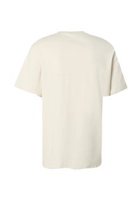 T-shirt en coton uni blanc cassé à manches courtes, vu de dos, avec un col rond et une coupe décontractée.