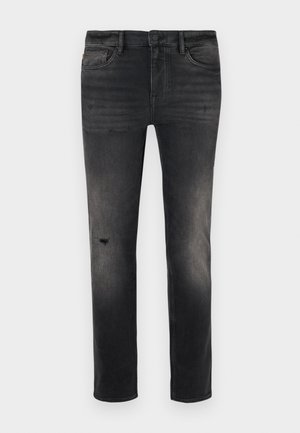 Slim-fit black denim jeans with fading, light distressing near the knee, five pockets, and standard button and zipper closure.