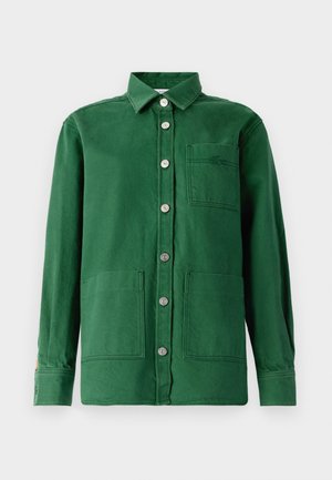 Green shirt made of cotton with a button-down front, two front pockets, and a collar. Features metal buttons and an embroidered logo on the pocket.