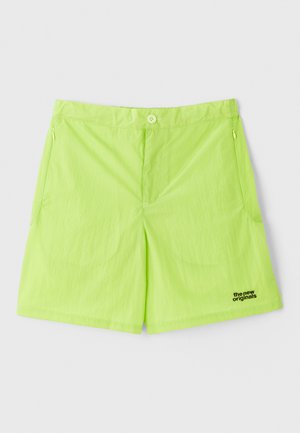 Neon green shorts made of lightweight fabric, featuring a button closure, two side pockets, and a logo on the lower right side.