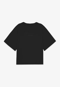 Černé, oversized tričko s krátkým rukávem z bavlny. Má decentní logo na hrudi a kulatý výstřih. Hladká textura.