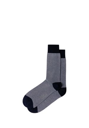 Pair of mid-calf socks with small black and white diamond pattern, black cuffs, heels, and toes on a white background.