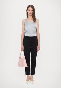 Light blue satin tank top, black elastic waist pants, pink handbag, and cream pointed-toe shoes. Simple design, smooth texture, and contrasting colors.