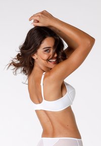 Reggiseno bianco con spalline regolabili, design senza cuciture e texture liscia. Stile minimalista senza motivi o accenti visibili.