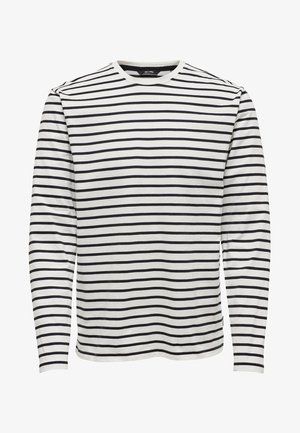 Camicia bianca a maniche lunghe con strisce orizzontali nere e scollo rotondo, mostrata su uno sfondo bianco neutro.