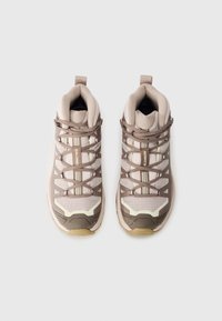 Brown and beige hiking shoes featuring a mesh upper, reinforced toe cap, and decorative stripes, with a textured sole for traction.