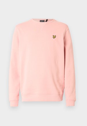 Rosa crewneck-genser laget av mykt stoff, med lange ermer og en liten svart og gul sommerfugl-logo på venstre bryst.