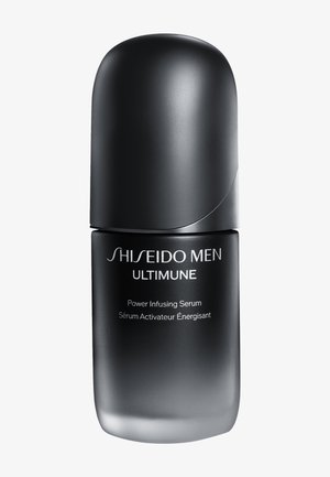 Bouteille de sérum noire en forme ovale avec une finition brillante. Présente du texte blanc à l'avant. Design effilé avec un couvercle arrondi et lisse.
