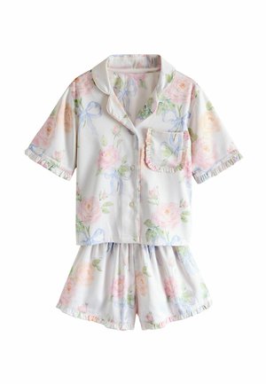 Short-sleeve button-up pajama top and matching shorts with pastel floral and bow patterns, featuring ruffled edges on sleeves, pocket, and shorts.