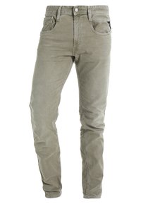 Elastyczne, oliwkowozielone spodnie o dopasowanym kroju wykonane z tkaniny z domieszką bawełny, z widocznym przeszyciem, pięcioma kieszeniami i zapięciem na metalowy guzik.