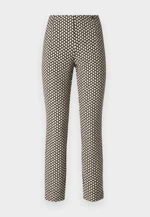 Patterned trousers with a fitted design, featuring a black background and small beige heart shapes. Material appears smooth and flexible.