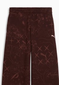 Pantalon marron foncé avec motifs d'étoiles abstraites et contours discrets du logo Puma, doté d'une taille élastique et d'un petit logo Puma blanc sur la jambe droite.