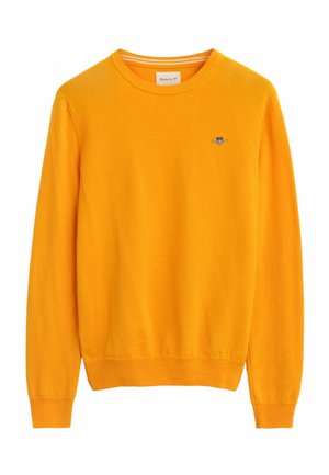 Yellow crew neck sweater made of soft fabric, featuring ribbed cuffs and hem, with a small embroidered logo on the chest.