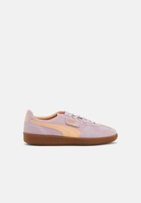 Purple suede sneakers with peach accents, featuring a rubber sole, lace-up front, and logo detailing on the side and tongue.