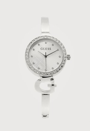Orologio da polso Guess argentato con ghiera tempestata di cristalli, quadrante minimalista con indici orari in cristallo e una decorativa "G" sul bracciale.