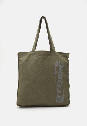 Olive green canvas tote bag with logo print, dual handles, square shape, visible stitching, and no additional patterns or accents.