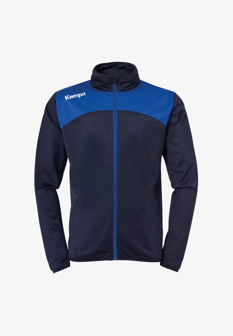 Marinefarbene Sportjacke mit blauen Akzenten, durchgehendem Reißverschluss, hohem Kragen, seitlichen Taschen und einem glatten, leichten Material. Mit "Kempa"-Logo.