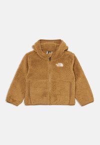 Rjava puhasta zip-up kapuca z logotipom The North Face na levi prsni strani in dvema sprednjima žepoma, položena na belo ozadje.