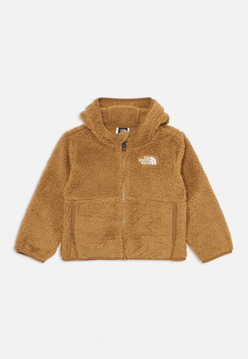 Brun fluffy zip-up hettejakke med The North Face-logo på venstre bryst og to frontlommer, lagt flatt på en hvit bakgrunn.