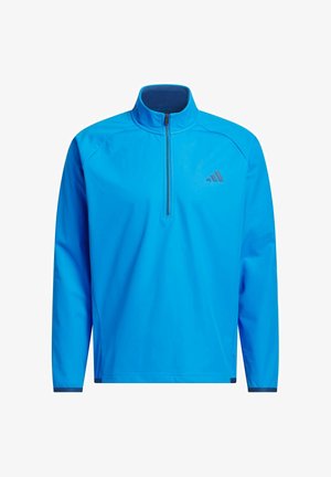 Pull-over de sport à manches longues bleu vif avec une fermeture éclair quart de longueur et un petit logo sombre sur la poitrine gauche.