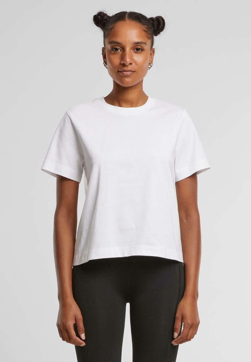 T-shirt blanc à manches courtes et col rond en coton. Présente une coupe décontractée et courte, et a une texture lisse sans motifs ni accents.
