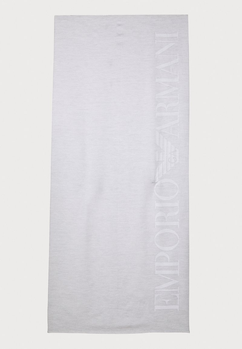 Light gray beach towel made of soft, textured fabric. Features a large embossed logo along one side, with a smooth surface overall.