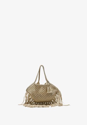 Beige woven straw handbag with long handles, decorative tassel, and fringe along the bottom and sides.