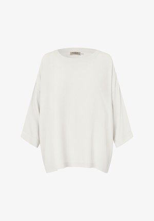 Camiseta blanca de manga larga con ajuste holgado, hombros caídos y escote redondo, mostrada sobre un fondo blanco.