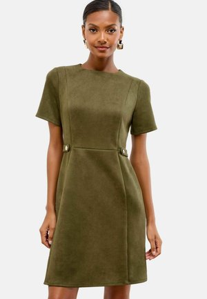 Olive green suede dress with a fitted bodice, short sleeves, and side button accents. Features an A-line silhouette and smooth texture.