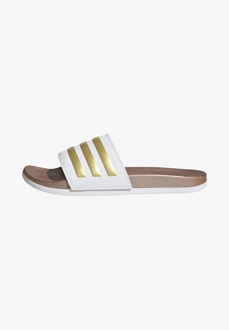 White slide sandals with three metallic gold stripes on the strap, featuring a brown textured footbed and white rubber sole.