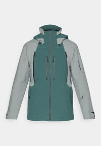 Két színű zöld és szürke kültéri dzseki több elülső cipzáras zsebel, állítható kapucni és logó a kézelőn.