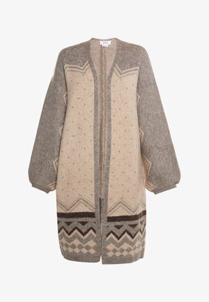 Cardigan oversize beige et gris en mélange de laine, avec des motifs géométriques, des manches bouffantes et une fermeture éclair devant. Texture douce.