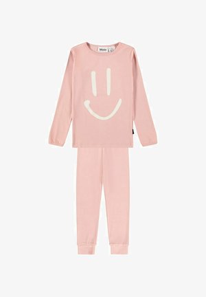 Ensemble haut à manches longues et pantalon rose clair avec un simple visage souriant blanc graphique sur la poitrine.