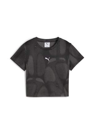 Sort cropped t-shirt med et prikket mønster og et lille hvidt Puma-logo på forsiden. Den har korte ærmer og en rund halsudskæring.