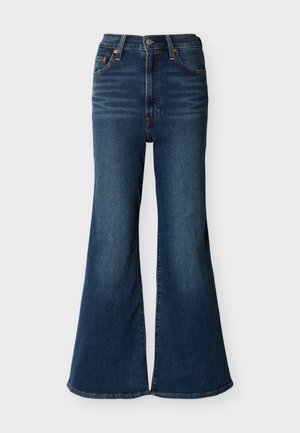 Mørkeblå højtaljede jeans med vidde i benene, lavet af denim, med forlommer og knappelukning foran.