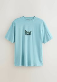 Lyseblå bomuld T-shirt med korte ærmer, med grøn kaktusembroidery og teksten "TERRY-URBAN" under designet.
