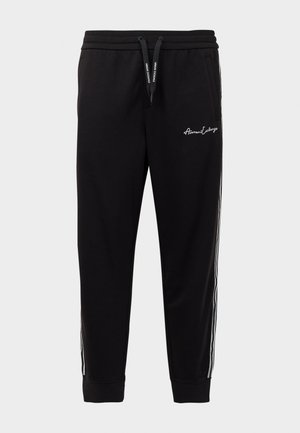 Schwarze Jogginghose aus Baumwollmischung mit einem gerippten Bund, seitlichen weißen Streifen und Logo-Stickerei auf dem linken Oberschenkel.