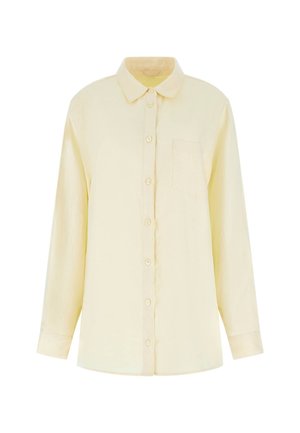 Kollane pikkade varrukatega nuppude jaotusega särk, mis on valmistatud kerge kangaga. Omab kraed ja ühte rinnataskut. Sile tekstuur.