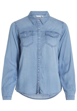 Lyseblå denimskjorte med lange ermer, knappestolpe foran, to brystlommer og avrundet kant. Har klassisk krage og subtil søm.