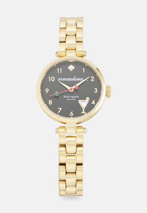 Gold-tone watch with a black dial, featuring a spade logo, colorful hour markers, and a cocktail glass motif. Chunky link bracelet design.
