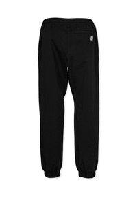 Schwarze Jogginghose mit lockerer Passform, elastischem Bund und Bündchen; verfügt über eine kleine Rückentasche und dezente Markenkennzeichnung.