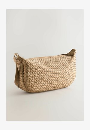 Woven beige bag with a curved shape, featuring a zip closure, adjustable strap, and a textured surface with a basketweave pattern.
